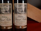 two bottles of wine sitting next to each other on a table
