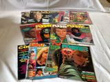 a lot of magazines on a bed with a white sheet