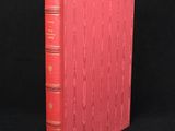 a red book sitting on top of a black surface
