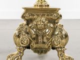 gold plated table with a lion head on top of it
