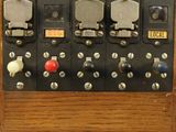 an old fashioned electrical panel with a clock on top of it