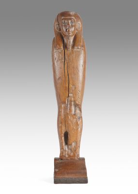 a wooden statue of a woman holding a baby in her arms