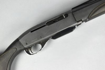 a close up of a gun on a white surface with a white background