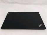 a black laptop sitting on top of a white sheet