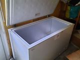 a white chest freezer sitting in the corner of a room