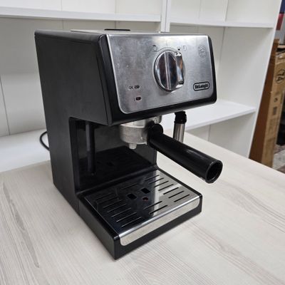 a black coffee machine sitting on a counter in a kitchen