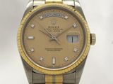 a gold and silver rolex watch with diamonds on the dial