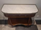 a marble top table with a drawer underneath it