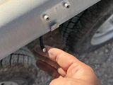 a person holding a piece of metal in their hand