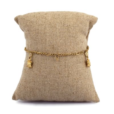 a close up of a pillow with a chain on it