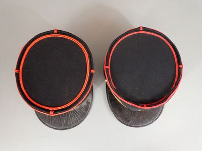 pair of black and red speakers on a white surface