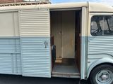 a blue and white trailer parked in a parking lot
