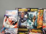a lot of comic books sitting on a table