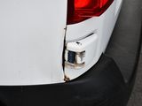 a close up of a white car with a hole in the rear