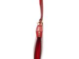 red leather handbag on a white background with a red handle