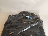 a pile of black clothing wrapped in plastic on a table