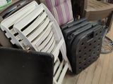a pile of chairs and a suitcase sitting on the floor