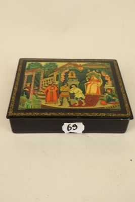 a black box with a painting on it sitting on a table