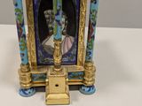a miniature clock with a picture of a man on it
