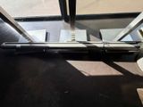 a gun that is laying on the floor next to a window