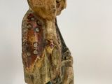 wooden statue of a woman holding a baby in her arms