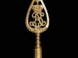 a close up of a gold spoon on a black background