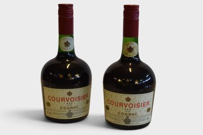 two bottles of wine sitting next to each other on a white surface