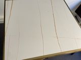 a white table with a gold frame on top of it