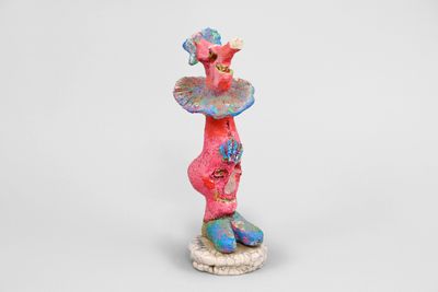 ceramic figurine of a woman with a hat on her head
