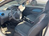 the interior of a small car with a steering wheel and a dashboard