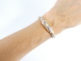 a woman ' s arm with a bracelet that has diamonds on it