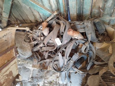 a pile of old shoes and other items inside of a building