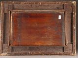 an old wooden picture frame with a tag on it