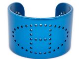 a close up of a blue bracelet with holes on it