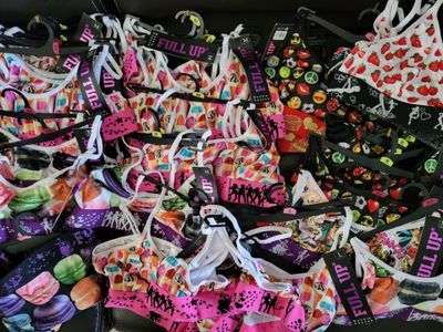 a lot of bras that are on a black couch