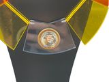 yellow, orange, and black necklace with a golden emblem on a black mannequin