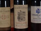 three bottles of wine are lined up on a table