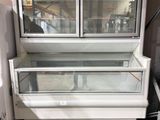 a refrigerator that is sitting in the middle of a room