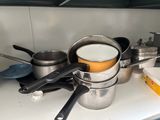 many pots and pans on the counter in the kitchen