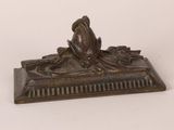 a bronze figurine of a woman sitting on a bench