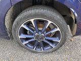a close up of a tire on a blue car