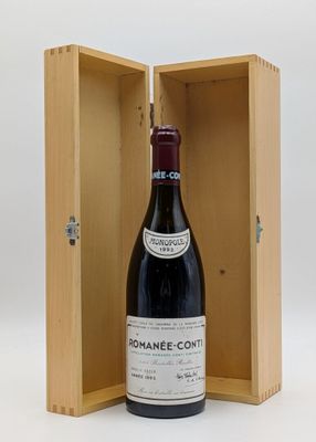 an open wooden box with a bottle of wine inside of it