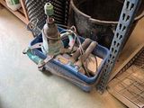a blue tray with tools and a bottle of wine on the floor