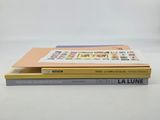 two books are stacked on top of each other on a table