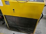 a yellow machine that is sitting in the garage