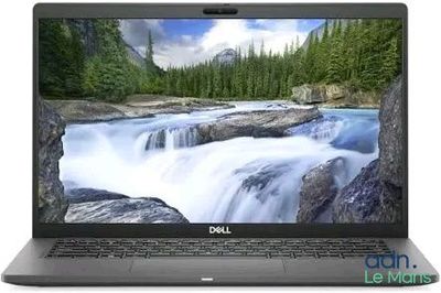 On voit un ordinateur portable Dell avec une cascade en arrière-plan.