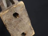 a metal padlock that has a hole in the middle of it