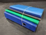 three blue and green folders tied together on a black surface