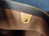 the inside of a brown and black purse with a zipper