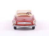 a red toy car that is sitting on a white surface